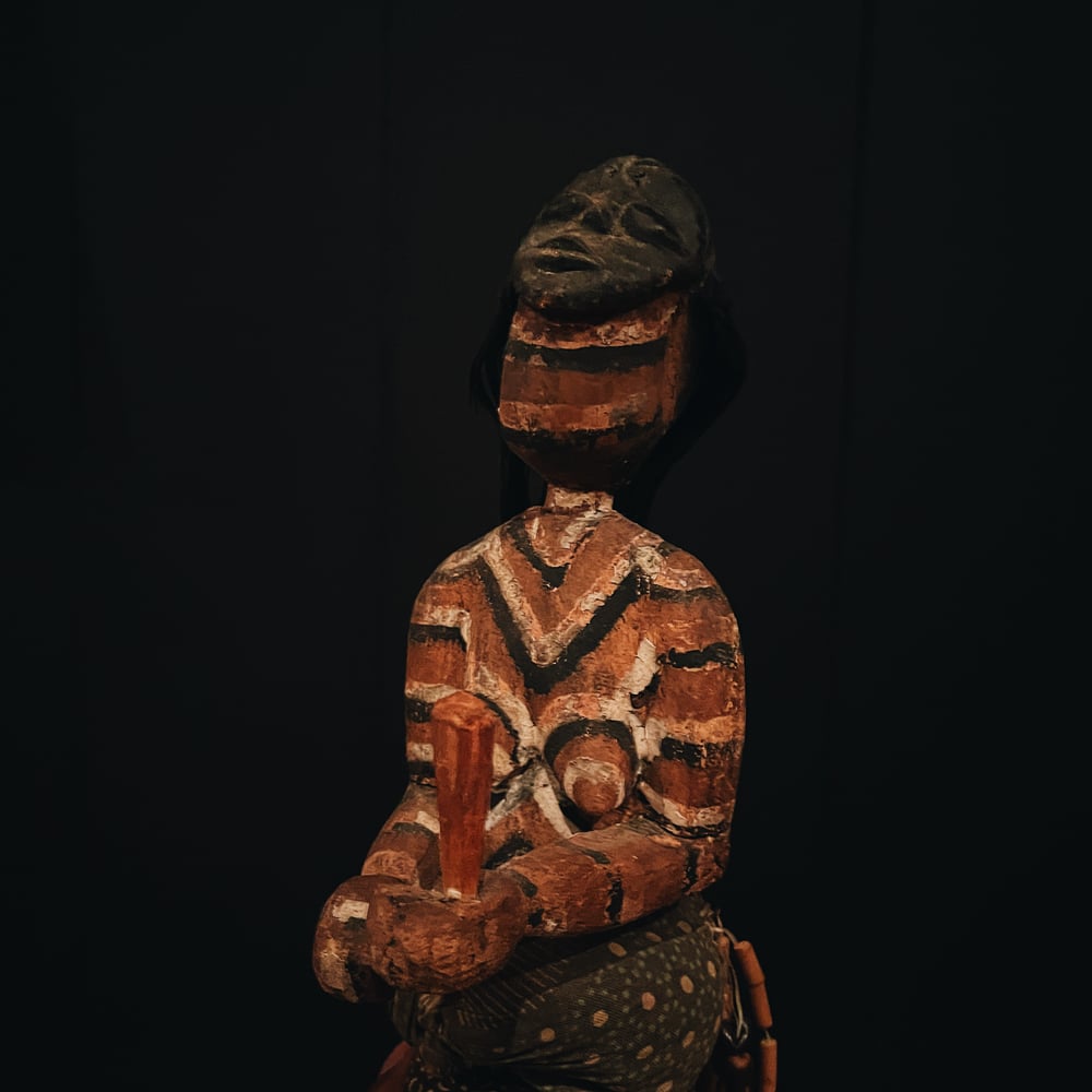 Carved Figure of a Woman with Mask