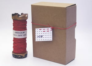 Image of Red Paper Twine on an Old Braider's Bobbin