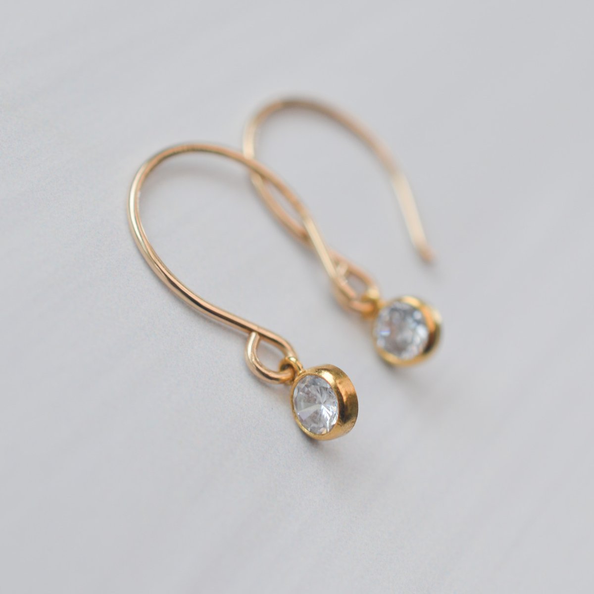 Image of Tiny Golden Hoop Earrings Bezeled CZ Round