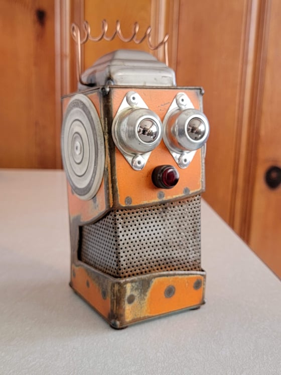 Image of Orange metal robot coin bank
