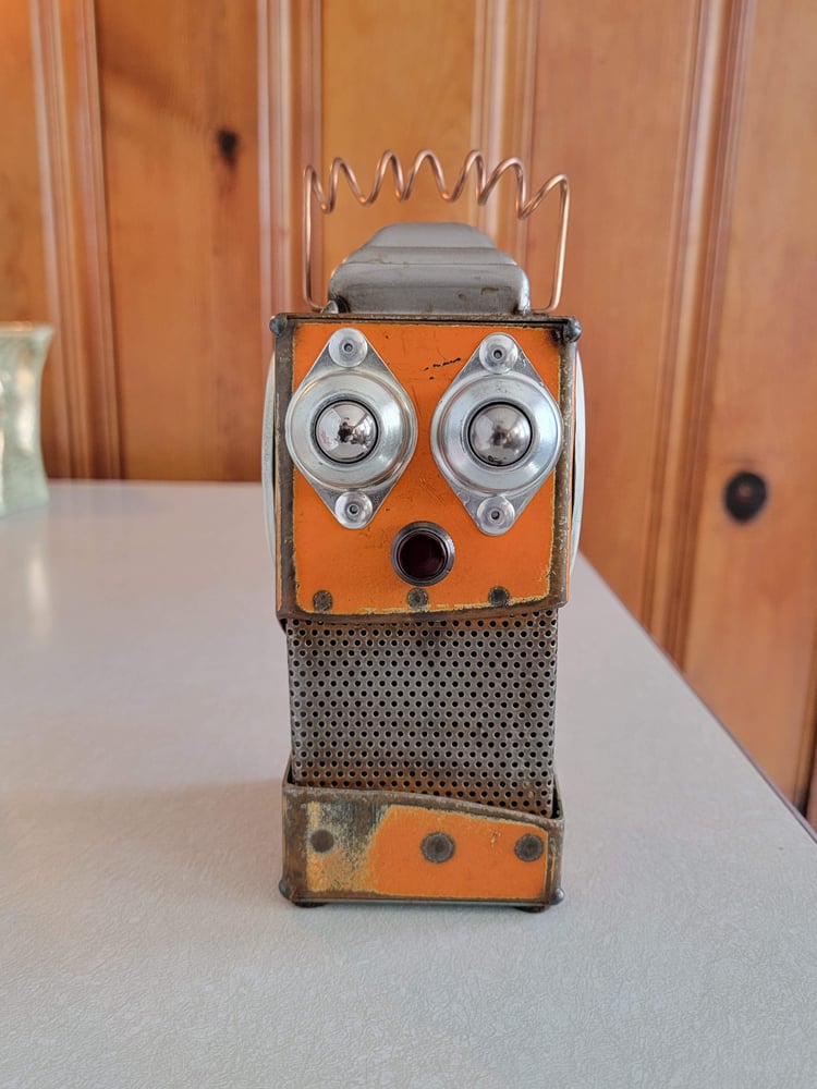 Image of Orange metal robot coin bank 