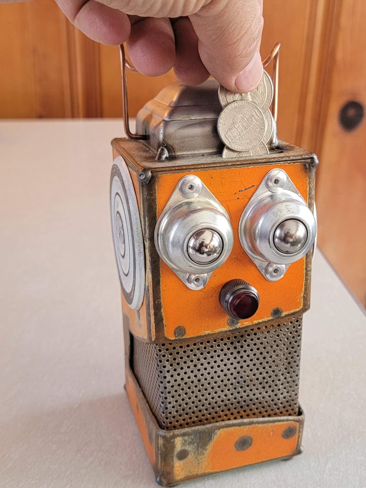 Image of Orange metal robot coin bank 