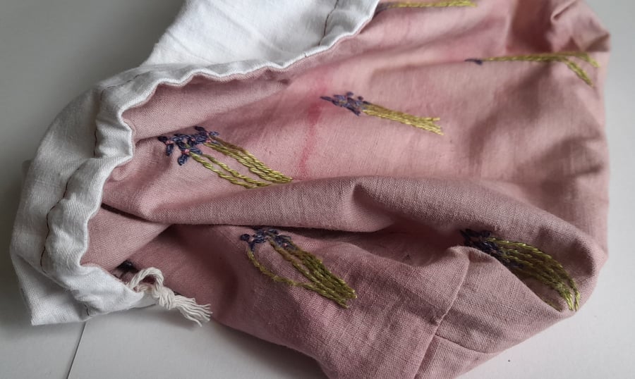 Image of pink string bag with violets