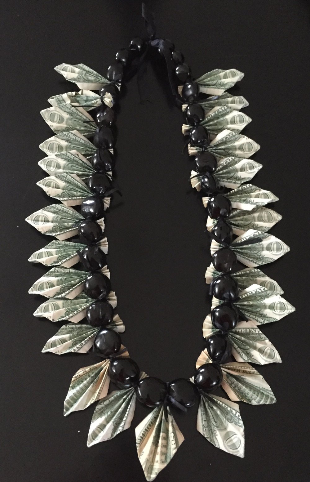 Image of black kukuinut money lei