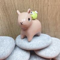 Image 1 of capybara with frog ceramic figurine