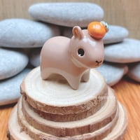 Image 2 of capybara with orange ceramic figurine