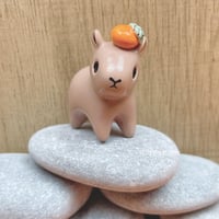 Image 4 of capybara with orange ceramic figurine