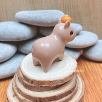 Image 5 of capybara with orange ceramic figurine