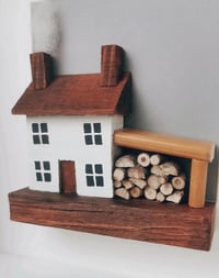 Image 2 of house with logs artwork