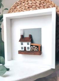 Image 4 of house with logs artwork