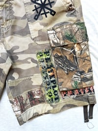 Image of just for protection patched camouflaged cargo shorts 