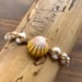 Image of Hawaiian sunrise shell with puka shell bracelet size 6 3/4