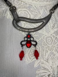 Image 1 of Asymmetrical Upcycled Necklace with Black And Red Gothic Charm.