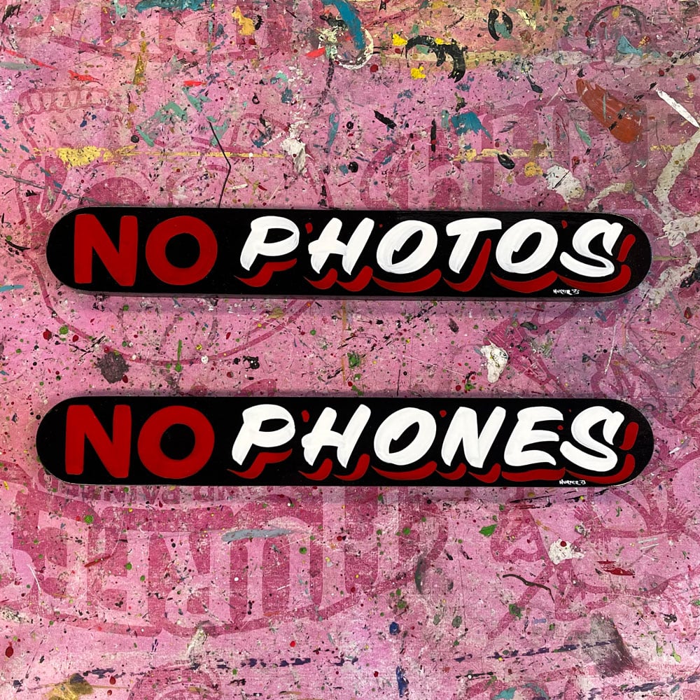 No Photos sign