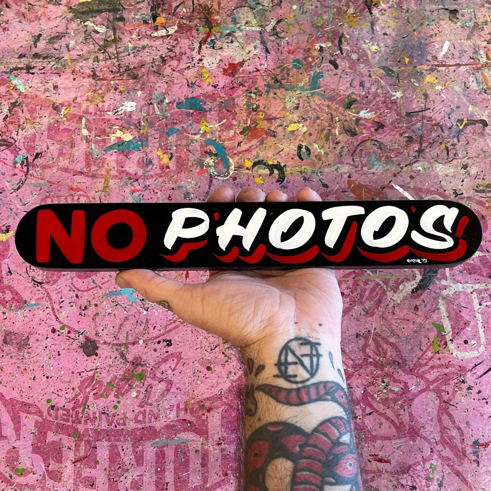 No Photos sign