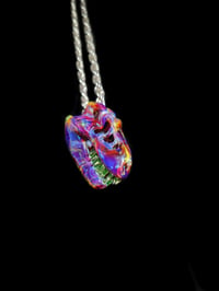 Image 1 of Mini amber purple T-REX skull pendant with illuminati teeth.