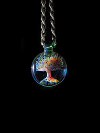 Image 1 of Psychedelic tree pendant backed in blue stardust.