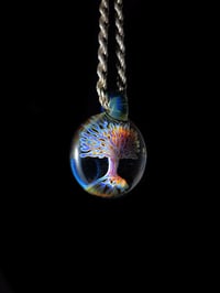 Image 2 of Psychedelic tree pendant backed in blue stardust.