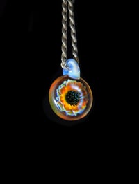 Image 1 of UV reactive psychedelic flower pendant.