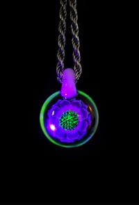 Image 4 of UV reactive psychedelic flower pendant.