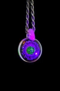 Image 5 of UV reactive psychedelic flower pendant.