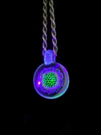 Image 5 of UV reactive psychedelic flower pendant..