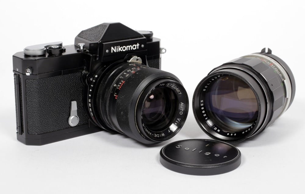 Image of Nikon Black Nikkormat FTn 35mm SLR film camera with 35mm and 135mm lenses #538