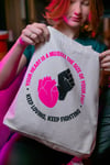 YOUR HEART IS A MUSCLE THE SIZE OF YOUR FIST Tote bag (Natural, with black and pink print)