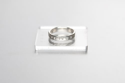 Image of silver ring for children with inscription in Latin