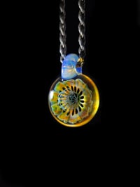 Image 1 of UV reactive psychedelic flower pendant with sacred Geometry dichro image center.