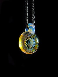 Image 3 of UV reactive psychedelic flower pendant with sacred Geometry dichro image center.