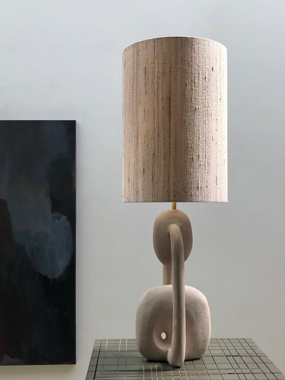 Image of hand shaped concrete table lamp