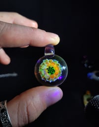 Image 1 of UV reactive psychedelic flower pendant. 🩷💚🌻