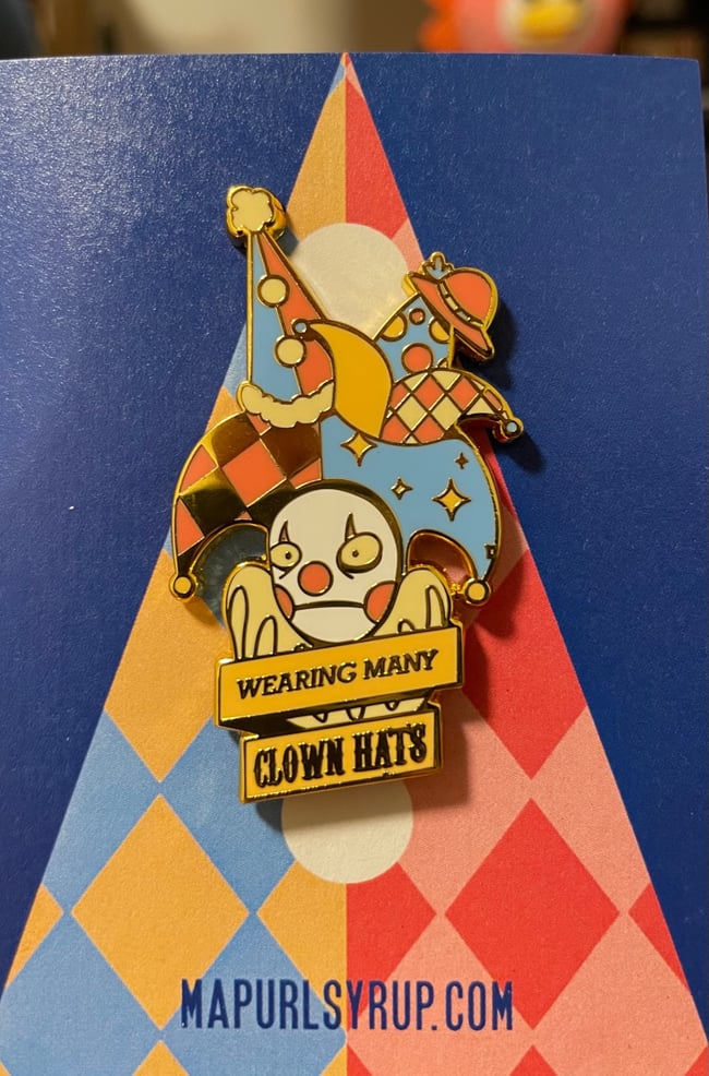 WEARING MANY CLOWN HATS Enamel Pin