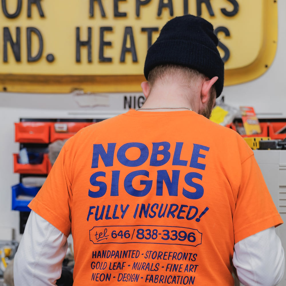 Noble Signs Official “Shop” T-Shirt (Orange)
