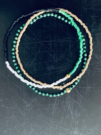 Green, White, Black, Gold Stack Bracelets. 