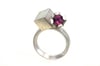 Rhodolite garnet in silver claw setting, interlaced with cube
