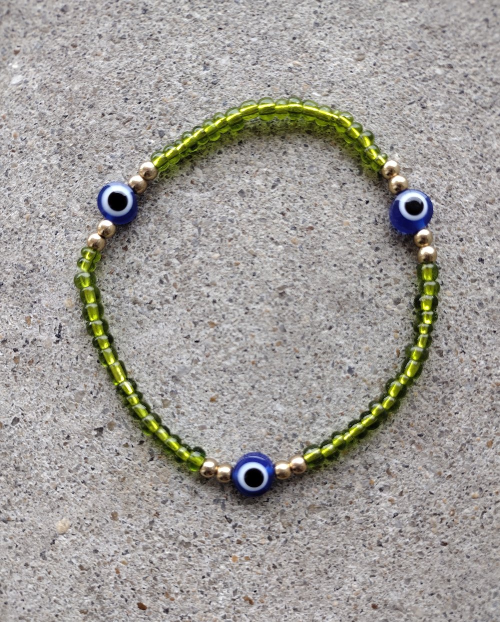 Image of Clear green + blue evil eye 
