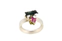 A contemporary ring featuring green and watermelon Tourmalines in a silver claw settings