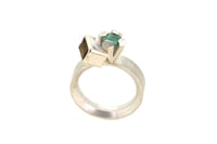 Image 3 of A contemporary ring featuring Orange Tourmaline and emerald in a silver claw setting