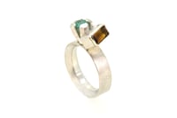 Image 4 of A contemporary ring featuring Orange Tourmaline and emerald in a silver claw setting