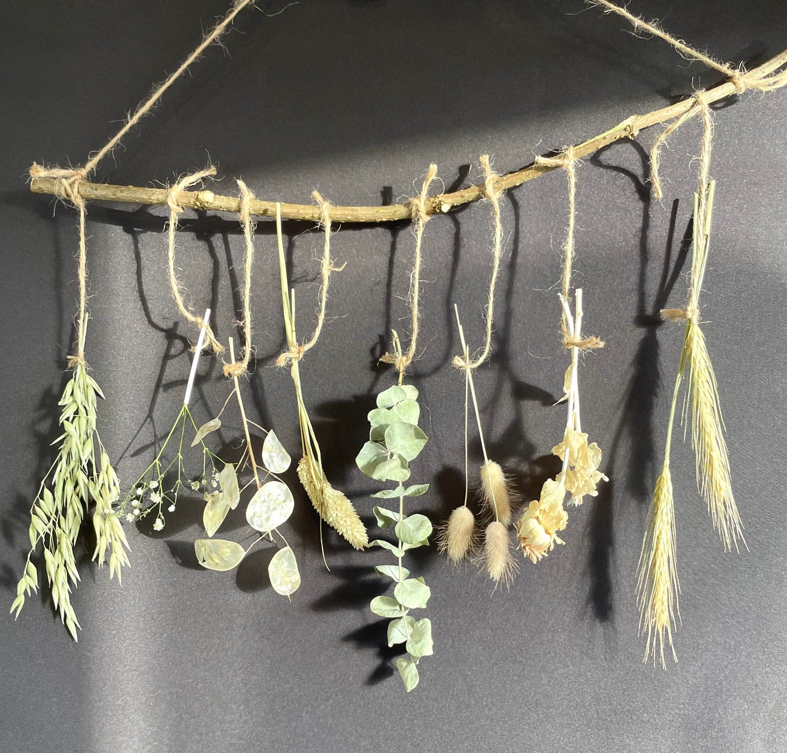 Rustic Decorative Wall Hanging of Branch with Dried Greenery and Garlic  Attached Against a Yellow Wall Stock Photo - Image of branch, floral:  186300294