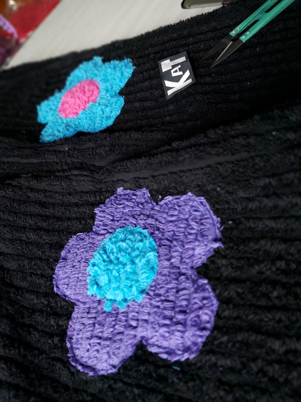 Image of Black chenille flower pants with pink, blue and purple flowers