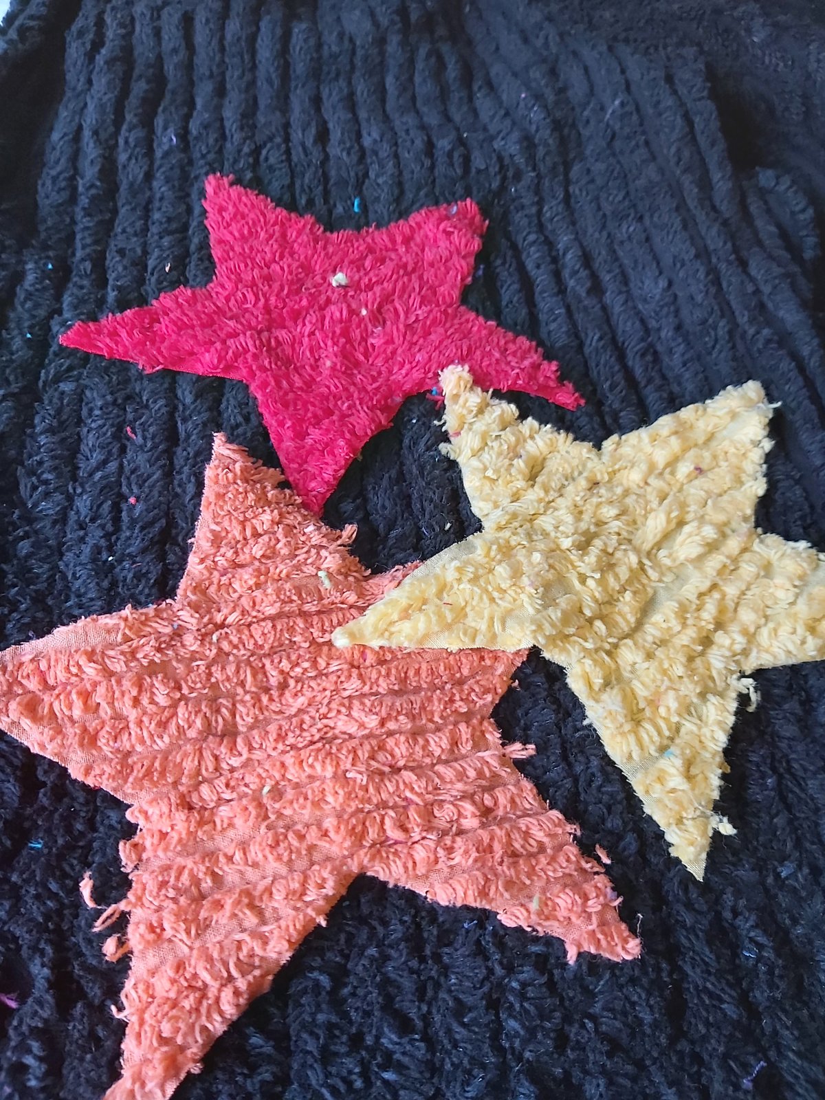Image of Black chenille pants with orange/red/yellow stars