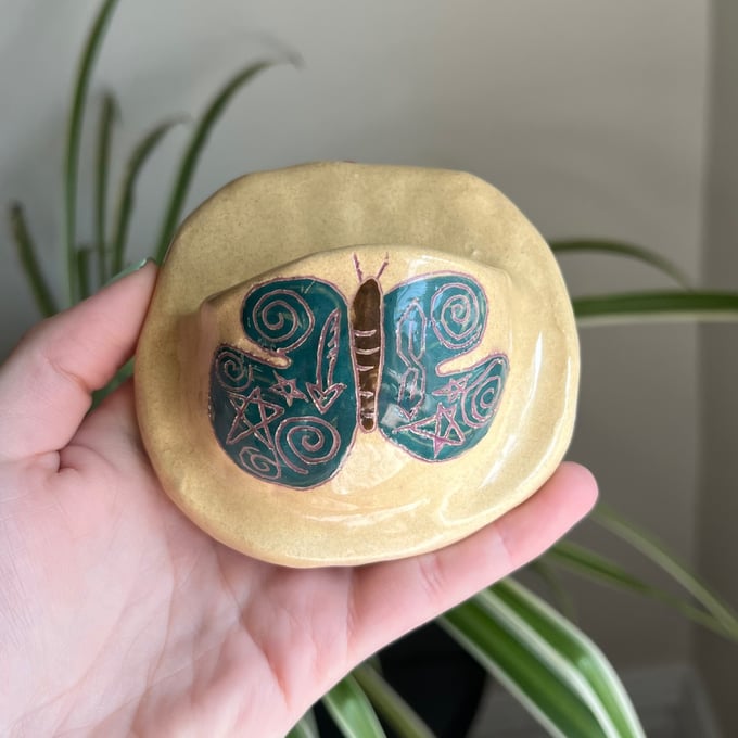 Image of ceramic tattooed butterfly shelf