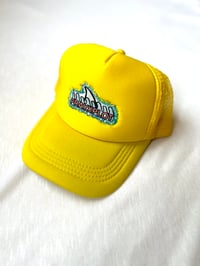 Image of shark in the water trucker cap in yellow 