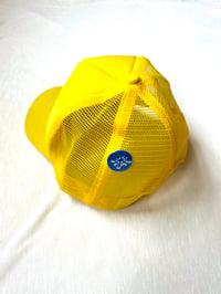 Image of shark in the water trucker cap in yellow 