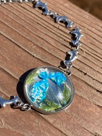 Image 2 of Steel Color Adjustable Bracelet. Dolphin. Blue Dried Pressed Flowers.