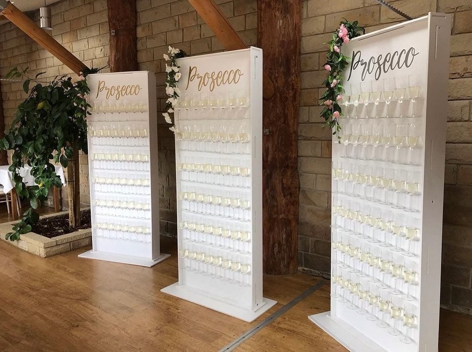 Image of 7ft Prosecco Wall hire with flutes and Prosecco 
