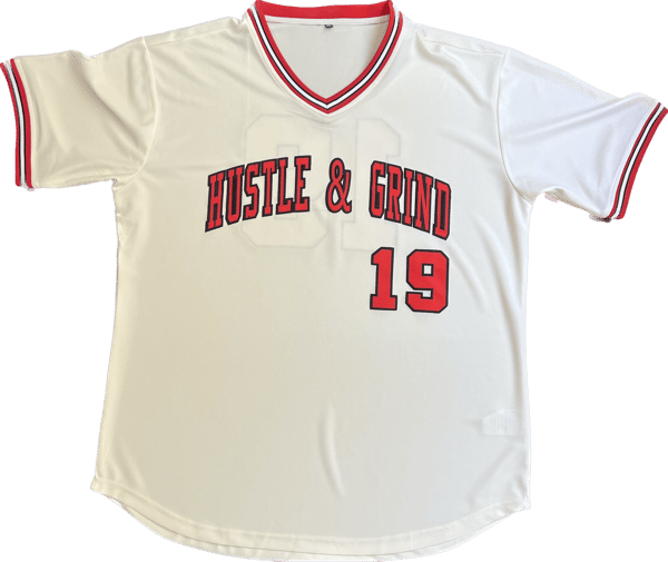 Image of Hustle & Grind Baseball Jersey Cream w/Red & Black letters.